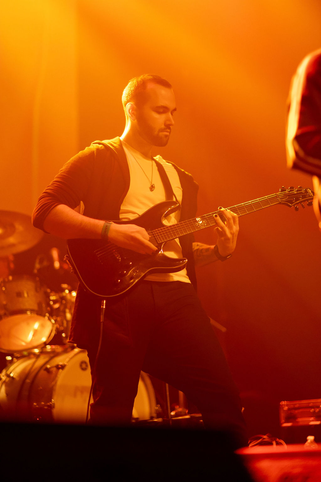 Mathieu De Pompa playing guitar at Eco Jam under coloured lights