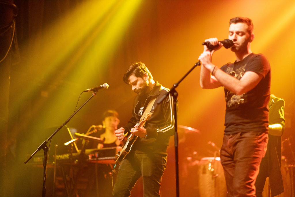 PUBLIC AMENITY performing at Eco Jam under colourful lights